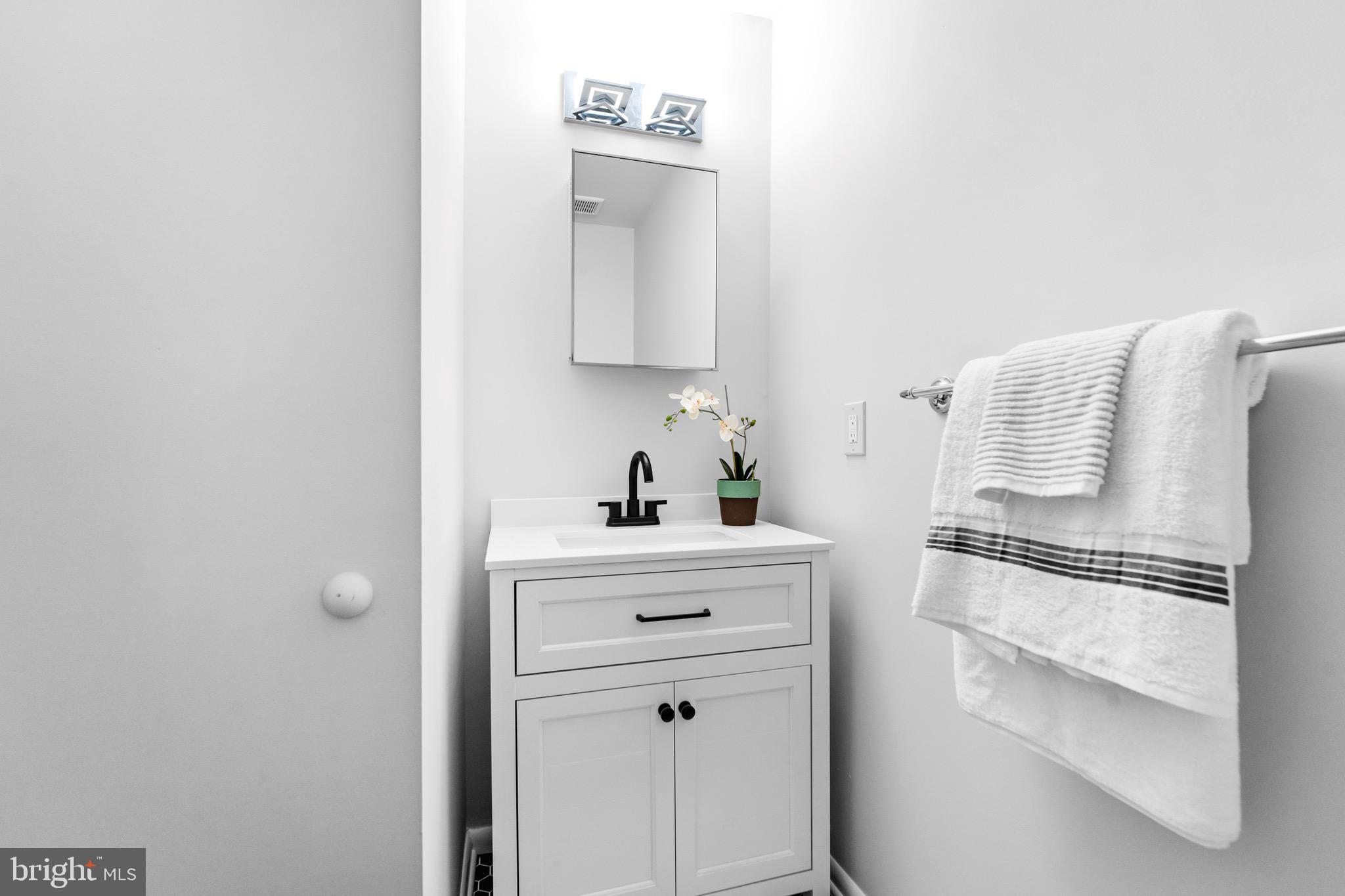 7512 Rolling Road Springfield, VA 22153 - Photo 17 of 32 a white kitchen with cabinets and appliances