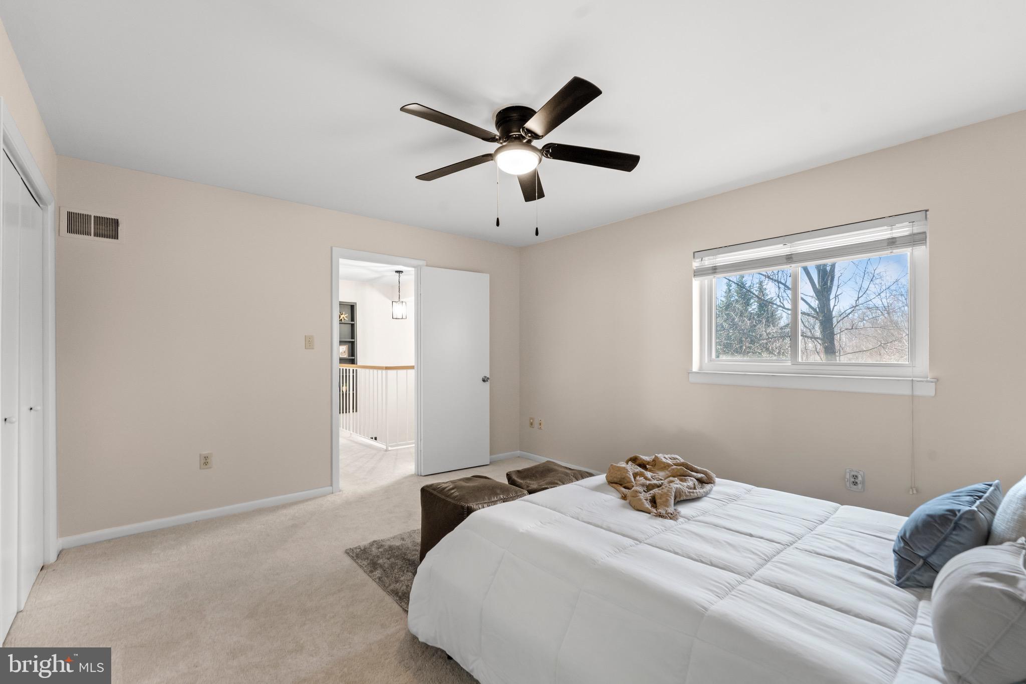 7512 Rolling Road Springfield, VA 22153 - Photo 20 of 32 a bedroom with a large bed and a window