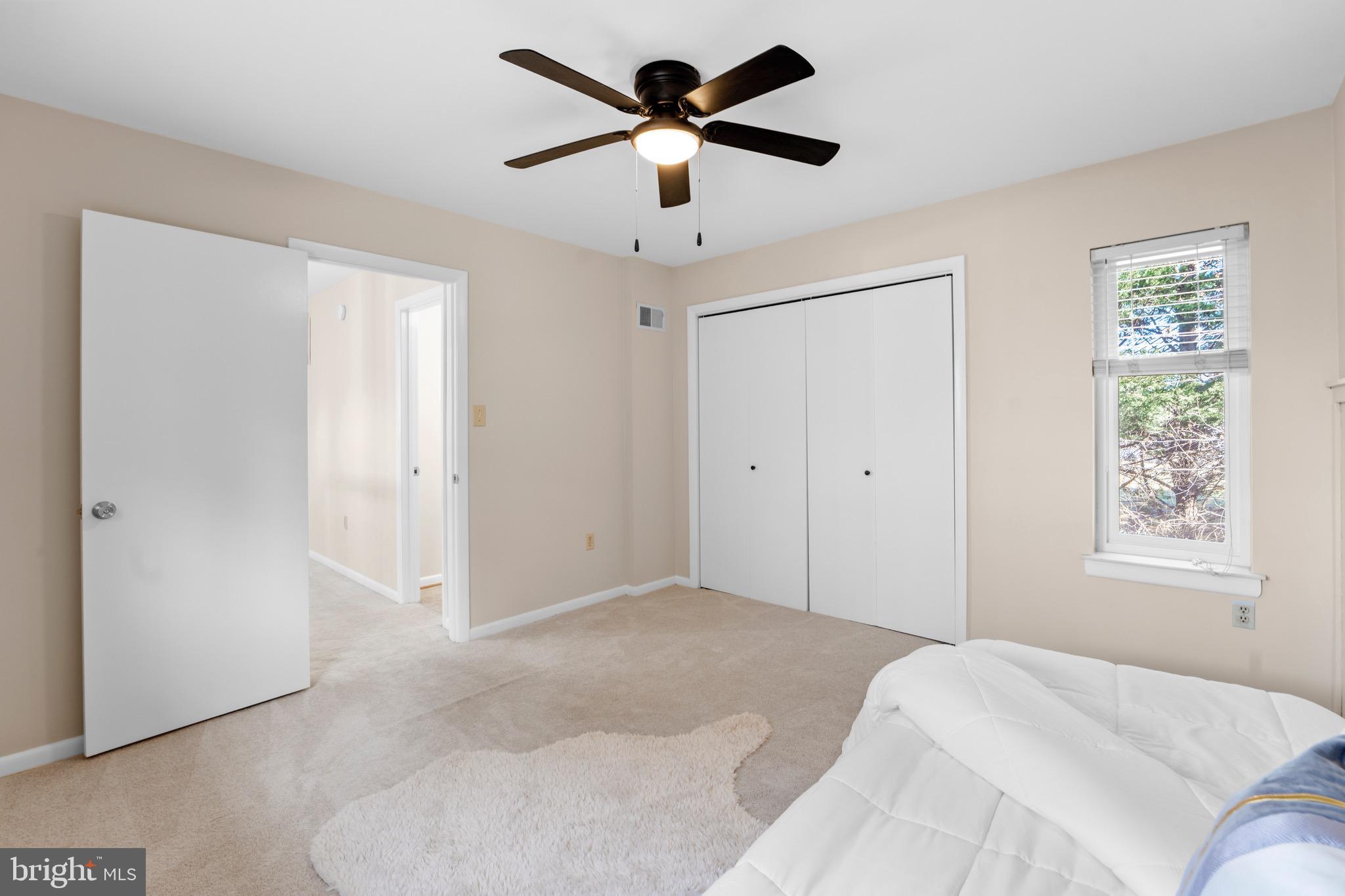 7512 Rolling Road Springfield, VA 22153 - Photo 22 of 32 a bedroom with a chandelier fan and windows