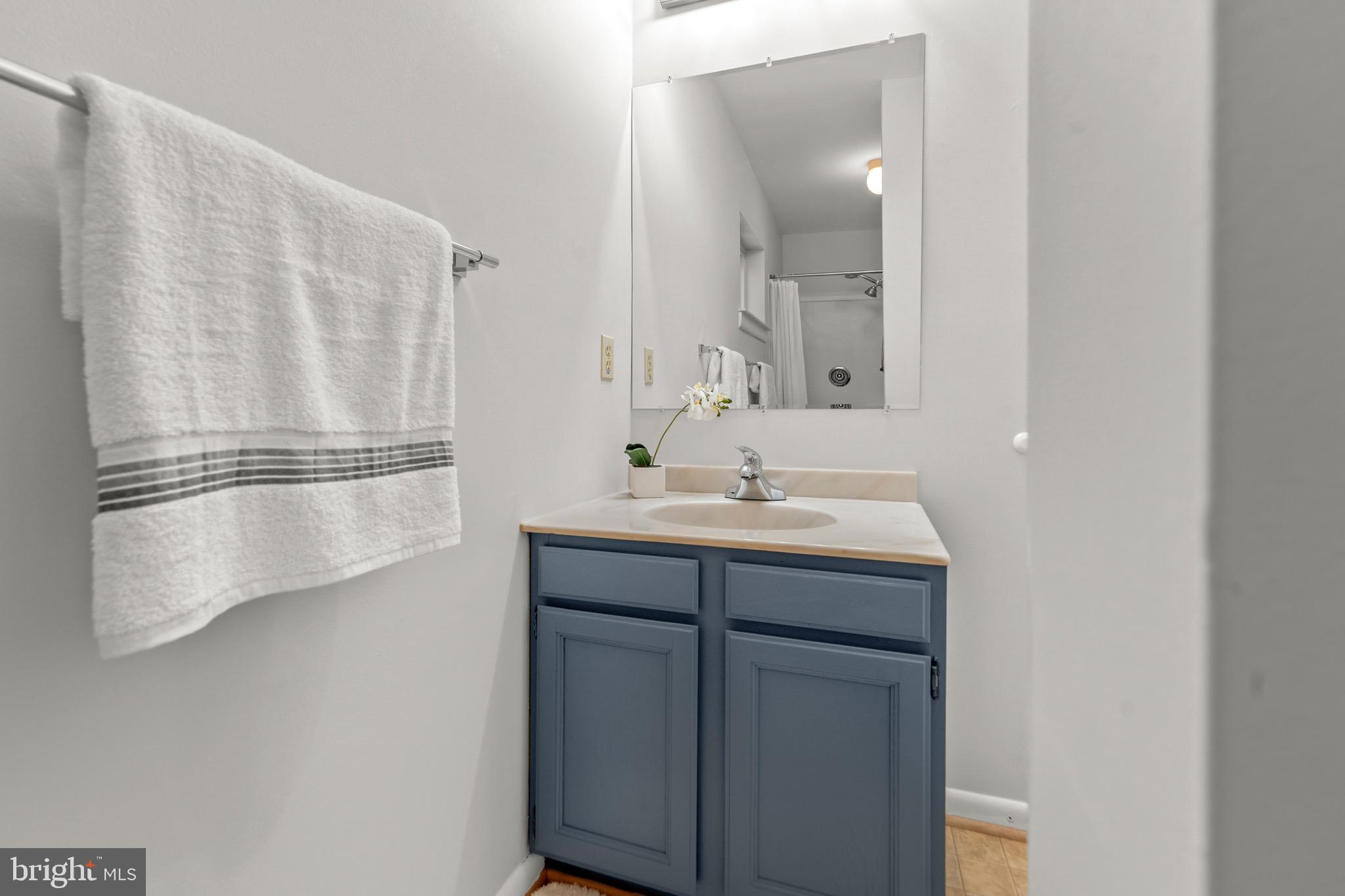 7512 Rolling Road Springfield, VA 22153 - Photo 23 of 32 a bathroom with a sink and mirror