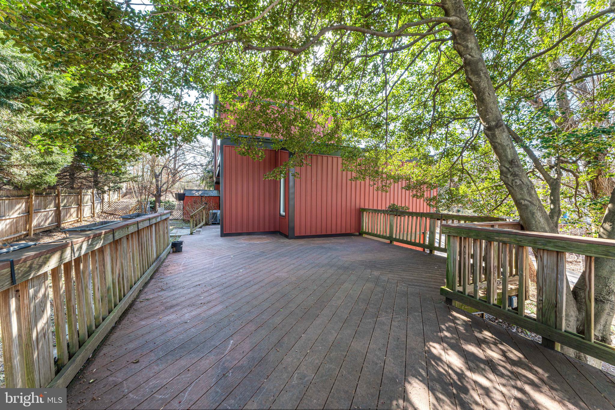 7512 Rolling Road Springfield, VA 22153 - Photo 28 of 32 a view of a deck with wooden floor and fence