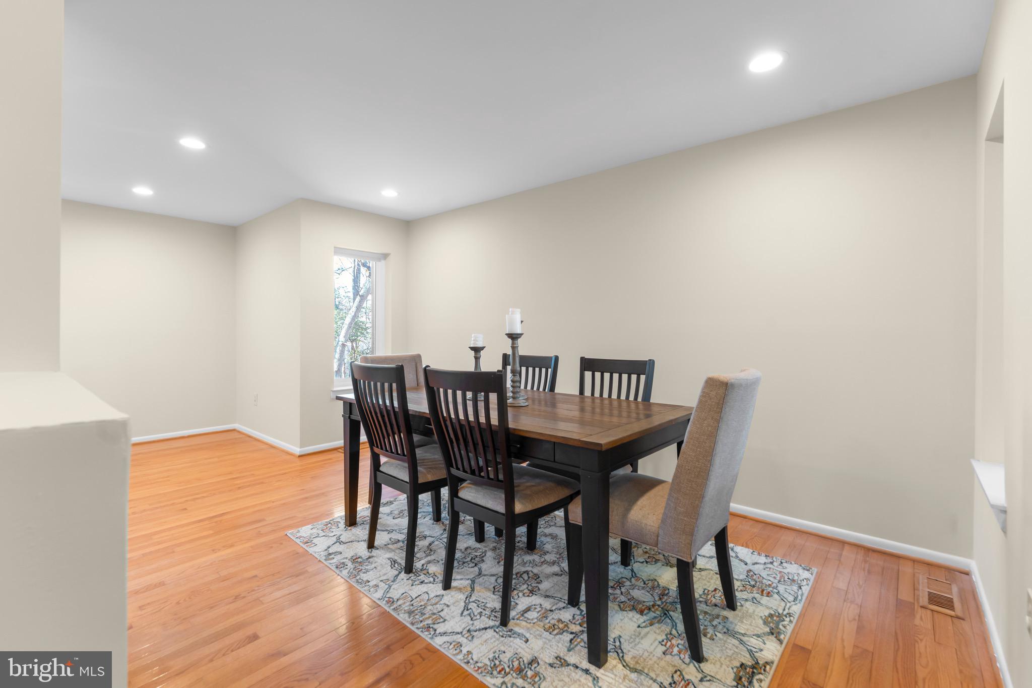 7512 Rolling Road Springfield, VA 22153 - Photo 7 of 32 a view of a dining room with furniture and wooden floor