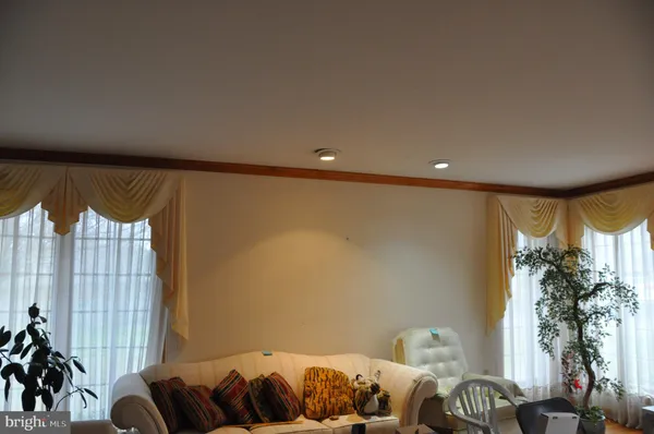 a view of a livingroom with wooden floor and a flat screen tv