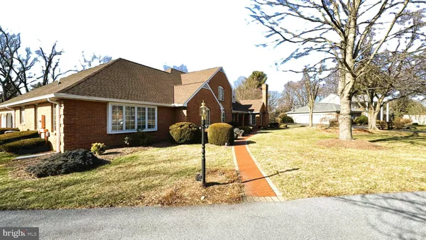 a front view of a house with a garden and yard