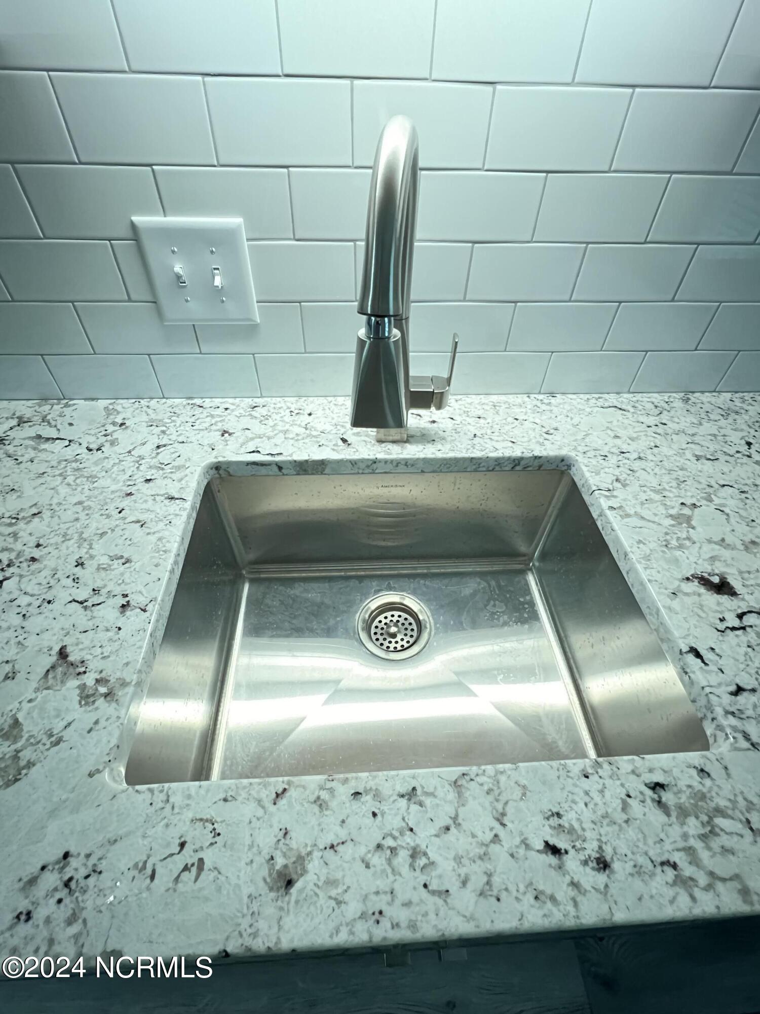 209 Bonnie Brook Road, Unit 1 Aberdeen, NC 28315 - Photo 5 of 14 Granite and tile backsplash