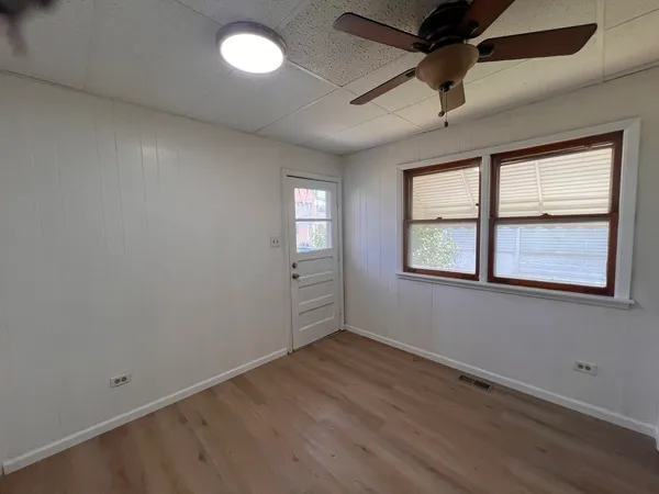 a view of a room with wooden floor