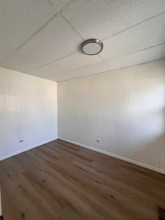 a view of a room with wooden floor