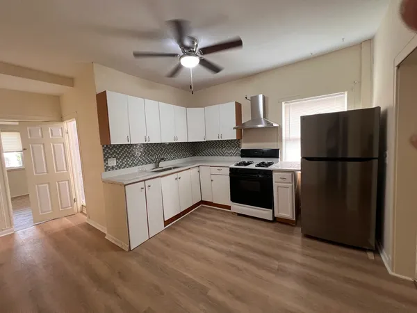 a kitchen with a stove and a refrigerator