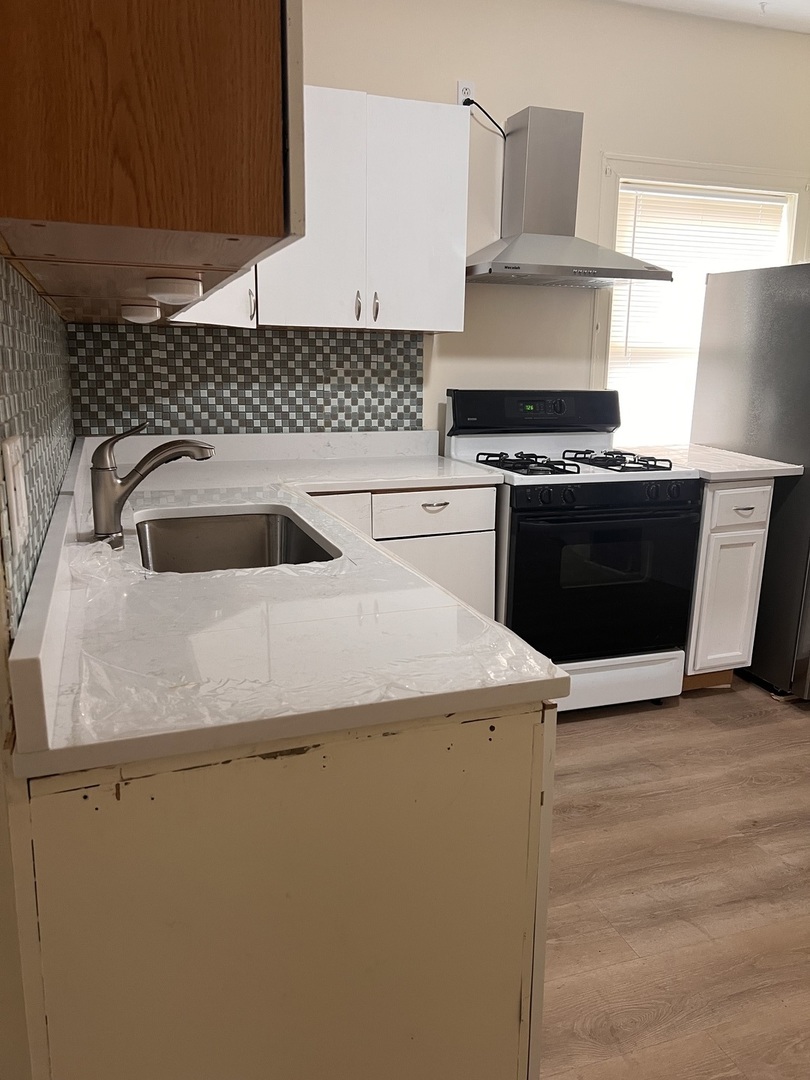 3741 South Union Avenue Chicago, IL 60609 - Photo 22 of 26 a kitchen with a stove and a refrigerator