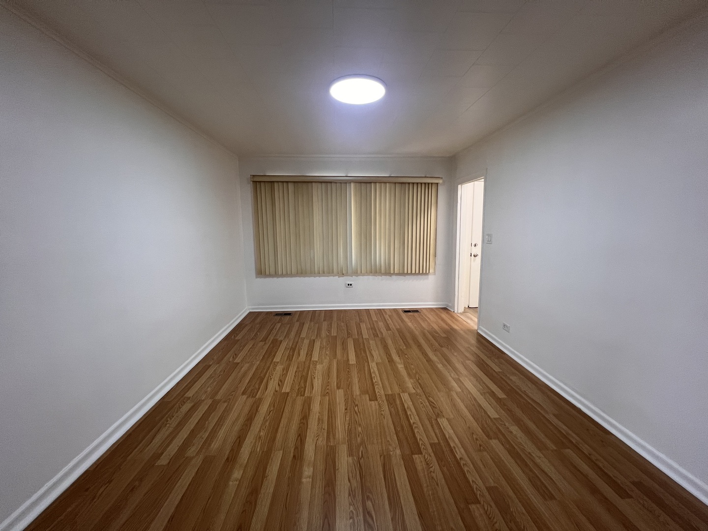 3741 South Union Avenue Chicago, IL 60609 - Photo 4 of 26 an empty room with wooden floor and windows