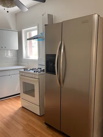 a large kitchen with a stove and a sink