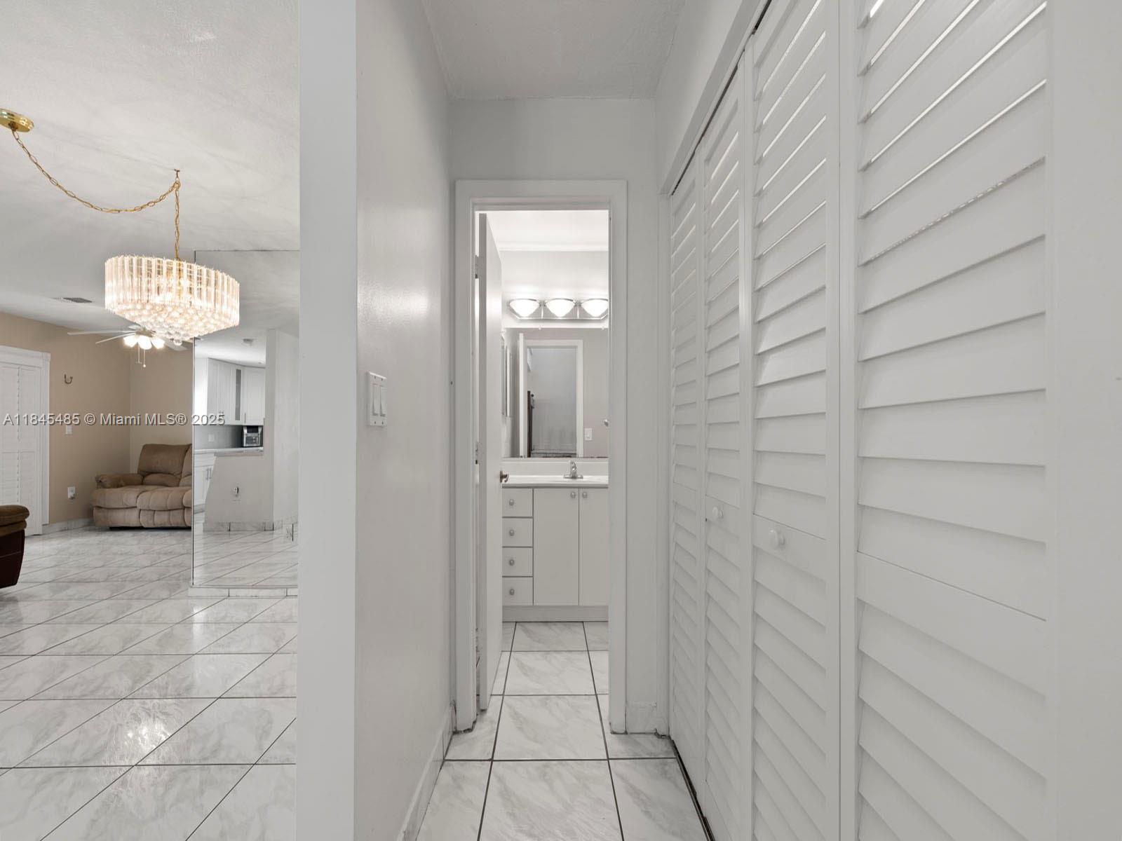 331 Northwest 101st Terrace Pembroke Pines, FL 33026 - Photo 12 of 42 a bathroom with a mirror and a shower