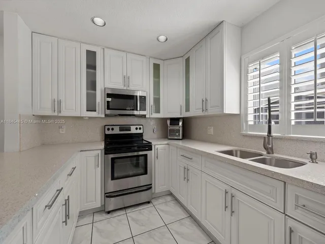 a spacious bathroom with a shower a mirror and a sink