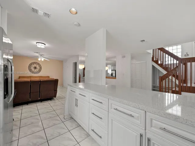 a living room with furniture a clock and a window