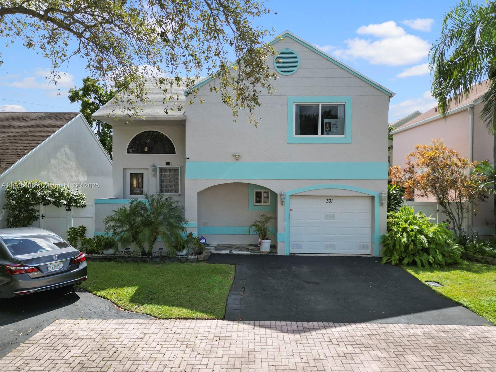 331 Northwest 101st Terrace Pembroke Pines, FL 33026 - Photo 2 of 42 a front view of a house with a yard