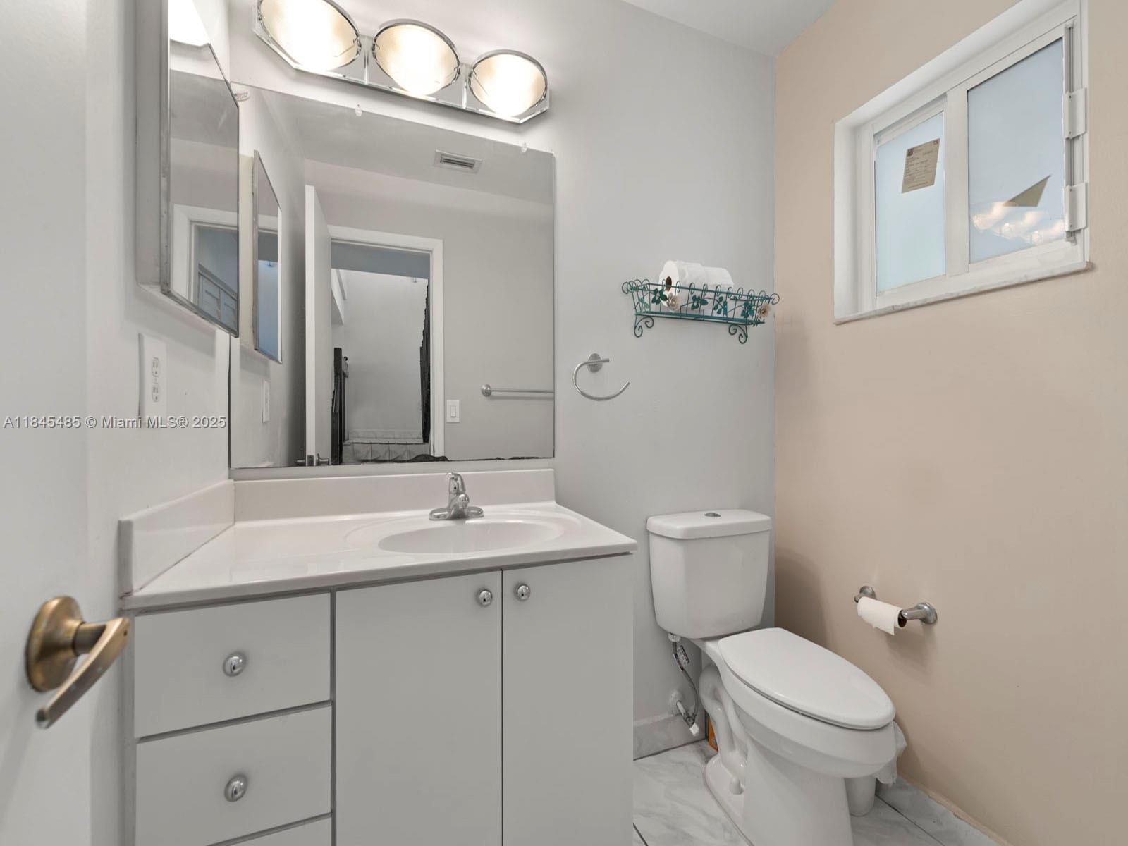 331 Northwest 101st Terrace Pembroke Pines, FL 33026 - Photo 23 of 42 a bathroom with a toilet sink and mirror