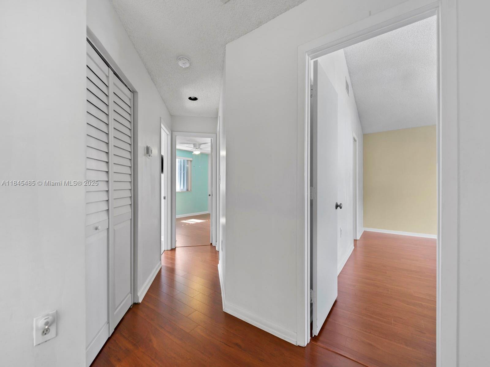 331 Northwest 101st Terrace Pembroke Pines, FL 33026 - Photo 29 of 42 a view of a hallway with wooden floor