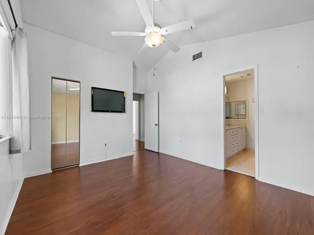 a bathroom with a granite countertop bathtub shower sink vanity and mirror