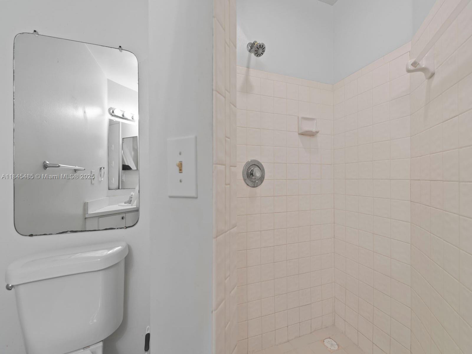 331 Northwest 101st Terrace Pembroke Pines, FL 33026 - Photo 38 of 42 a bathroom with a granite countertop sink a toilet and shower