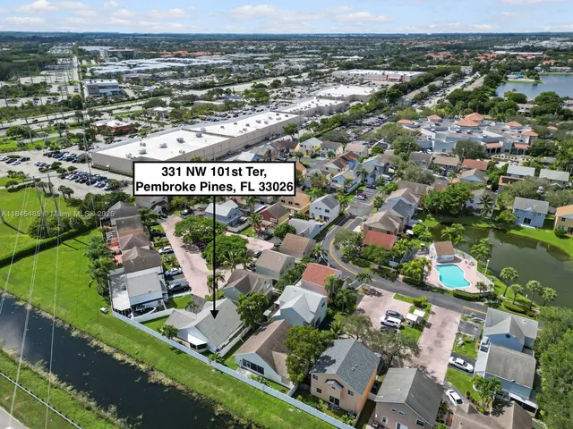 an aerial view of residential building and lake