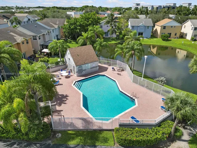 an aerial view of a house with outdoor space and lake view