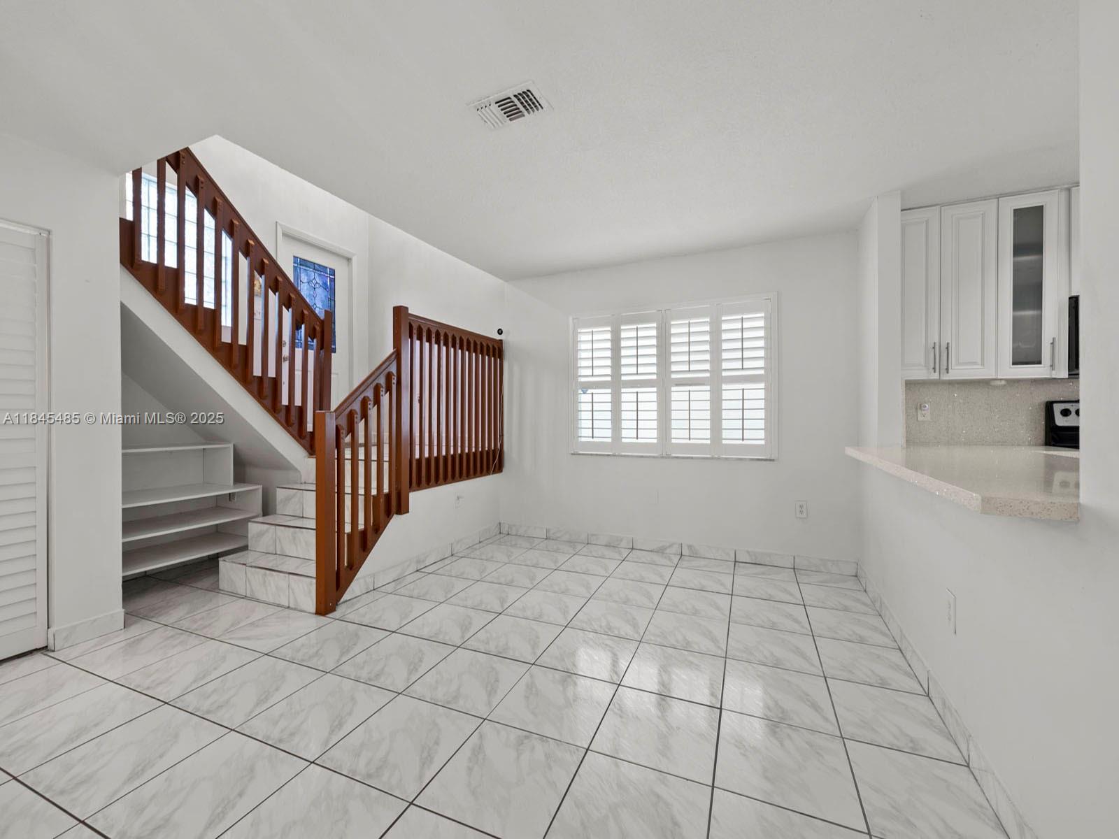 331 Northwest 101st Terrace Pembroke Pines, FL 33026 - Photo 10 of 42 a view of an empty room with a window