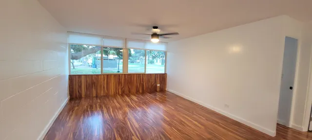 wooden floor in an empty room with a window