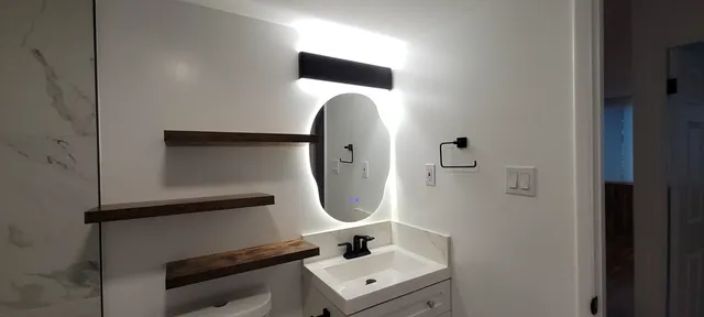 a bathroom with a sink and mirror