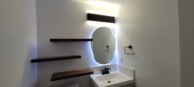 a bathroom with a sink and mirror