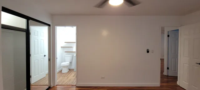 a view of a bathroom with a glass door and mirror