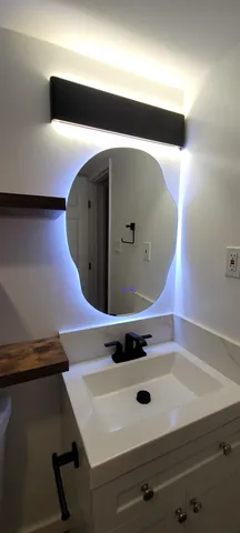 a bathroom with a sink and mirror