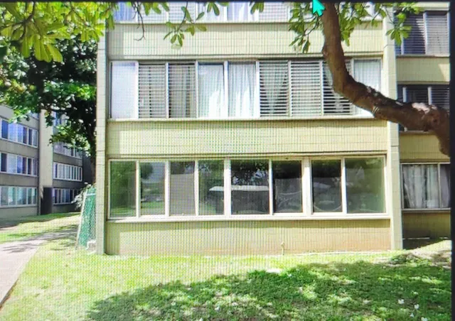a view of a brick house with a large window