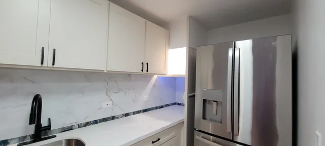 a room with cabinets and a refrigerator