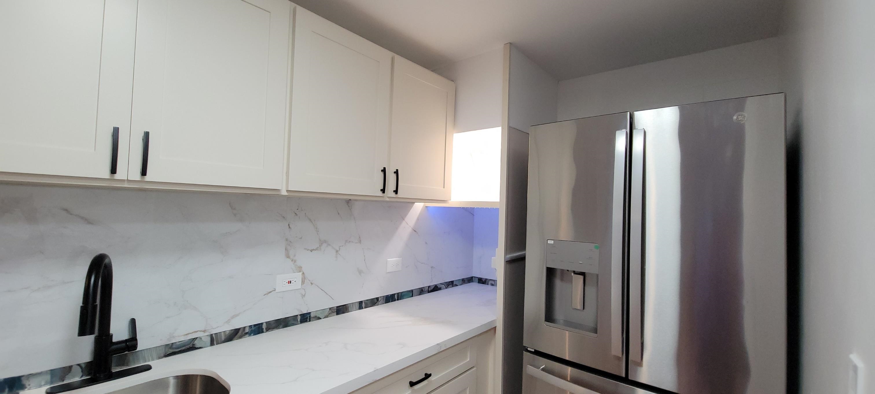 111 Kahului Beach Road, Unit A127 Kahului, HI 96732 - Photo 5 of 31 a room with cabinets and a refrigerator