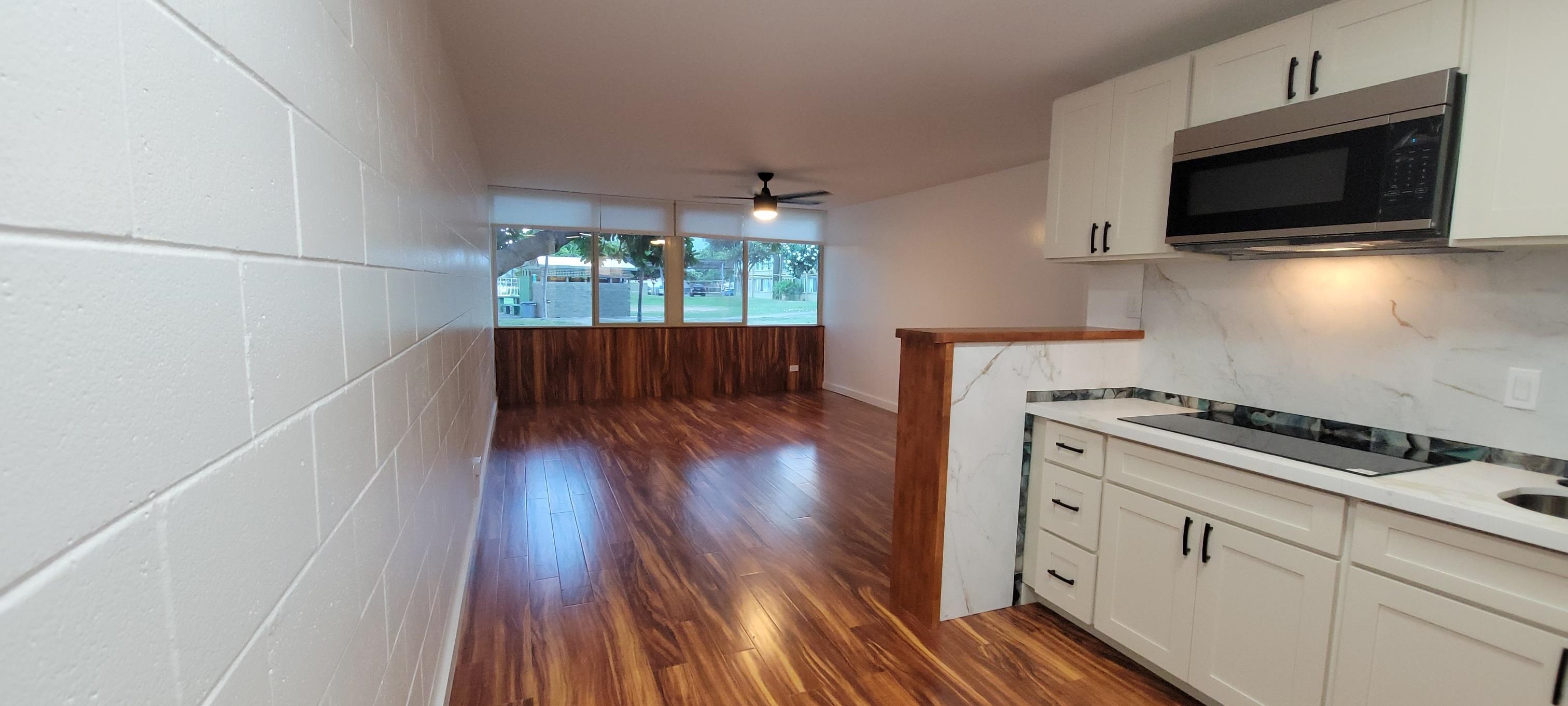 111 Kahului Beach Road, Unit A127 Kahului, HI 96732 - Photo 10 of 31 a kitchen with wooden floors and appliances