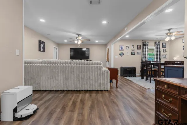 a living room with furniture and wooden floor