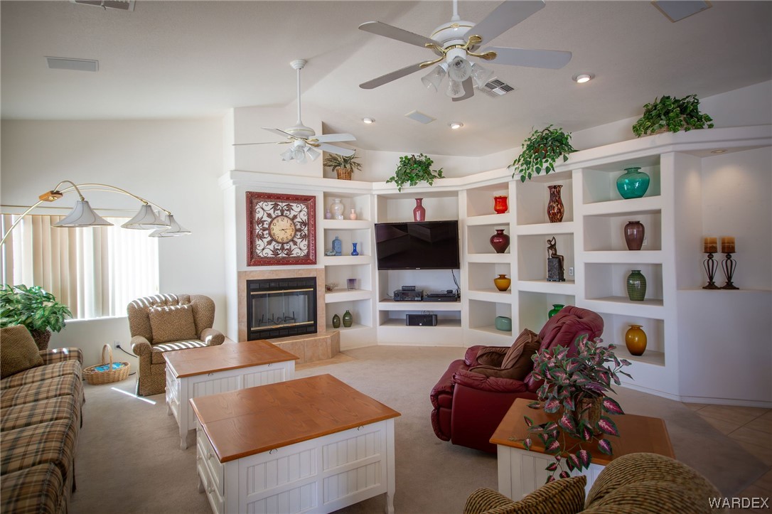 2660 Pegasus Ranch Road Bullhead City, AZ 86429 - Photo 12 of 57 a living room with furniture a flat screen tv and a fireplace