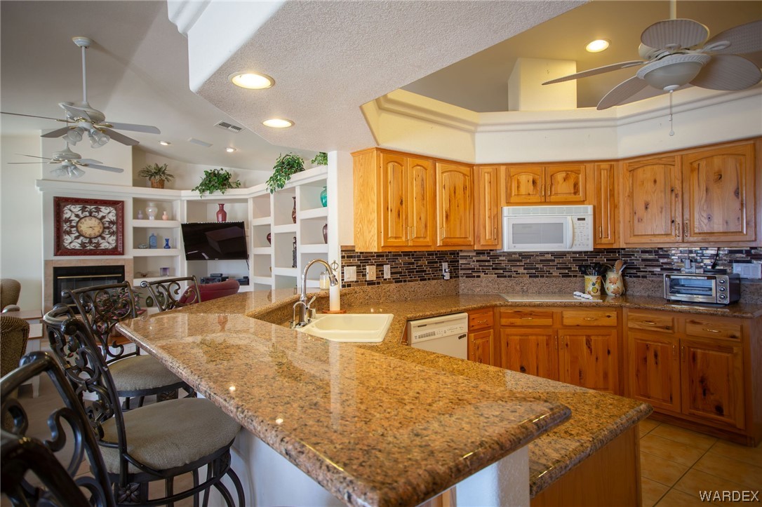2660 Pegasus Ranch Road Bullhead City, AZ 86429 - Photo 14 of 57 a kitchen with stainless steel appliances granite countertop a sink and a counter