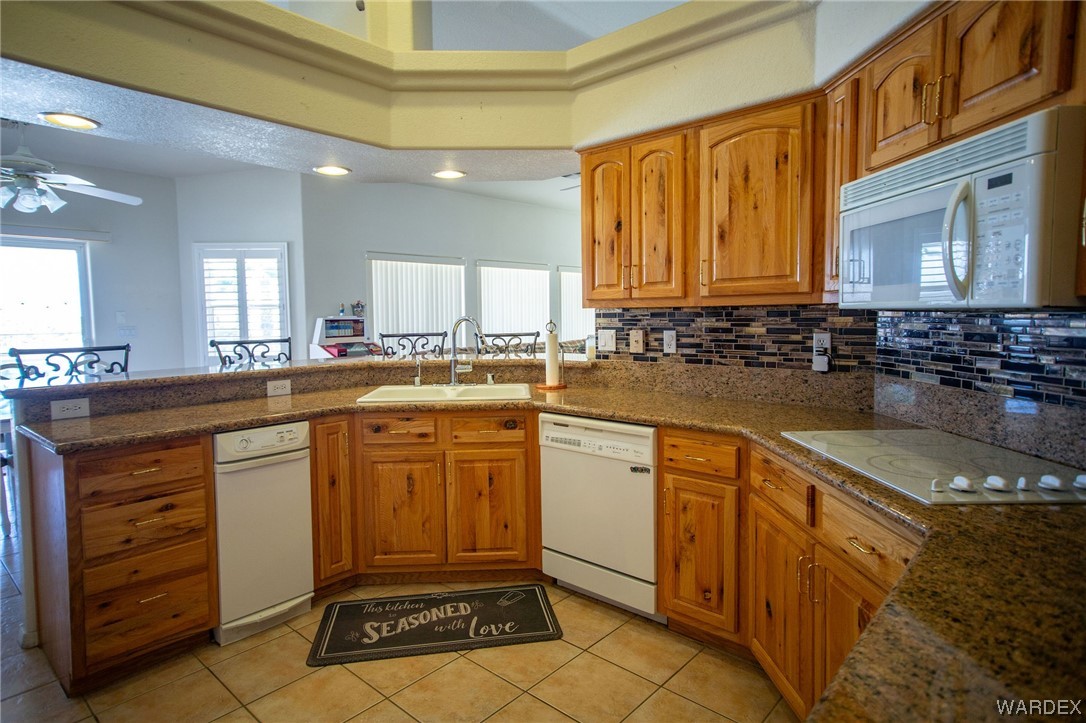 2660 Pegasus Ranch Road Bullhead City, AZ 86429 - Photo 15 of 57 a kitchen with stainless steel appliances granite countertop a sink and cabinets