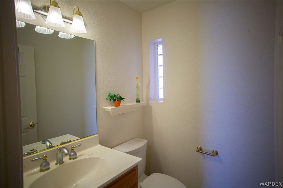 2660 Pegasus Ranch Road Bullhead City, AZ 86429 - Photo 18 of 57 a bathroom with a sink vanity granite and toilet