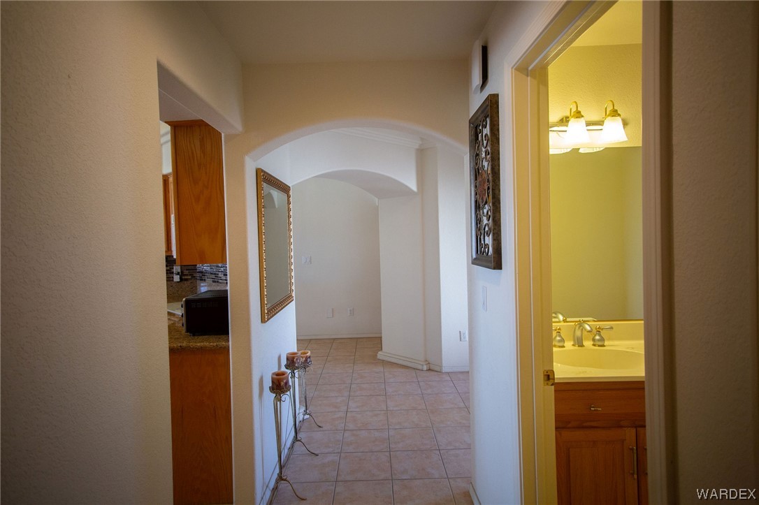 2660 Pegasus Ranch Road Bullhead City, AZ 86429 - Photo 20 of 57 a view of a hallway with wooden floor and a bathroom
