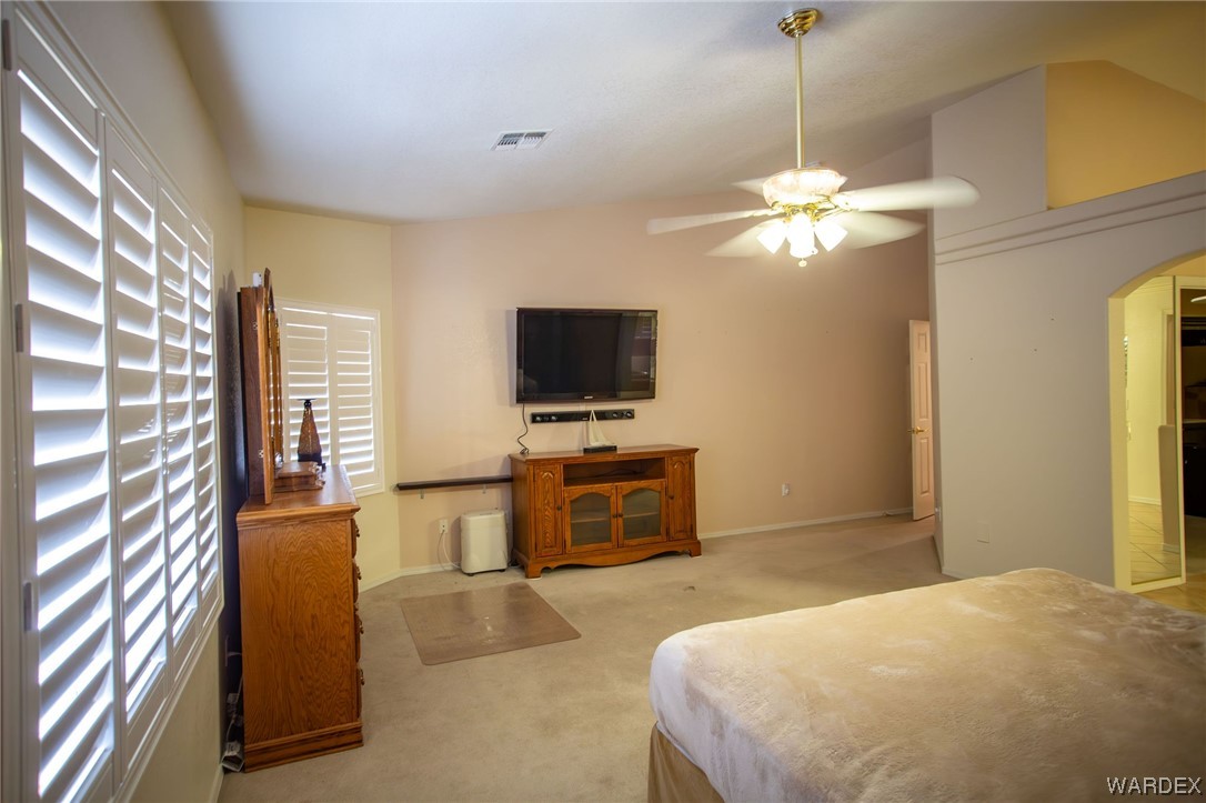 2660 Pegasus Ranch Road Bullhead City, AZ 86429 - Photo 22 of 57 a bedroom with a bed and a flat screen tv