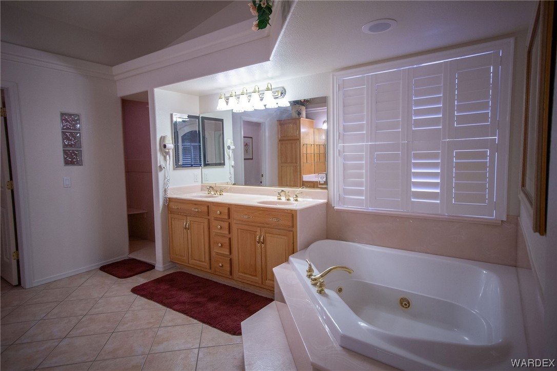 2660 Pegasus Ranch Road Bullhead City, AZ 86429 - Photo 24 of 57 a bathroom with a tub sink and mirror