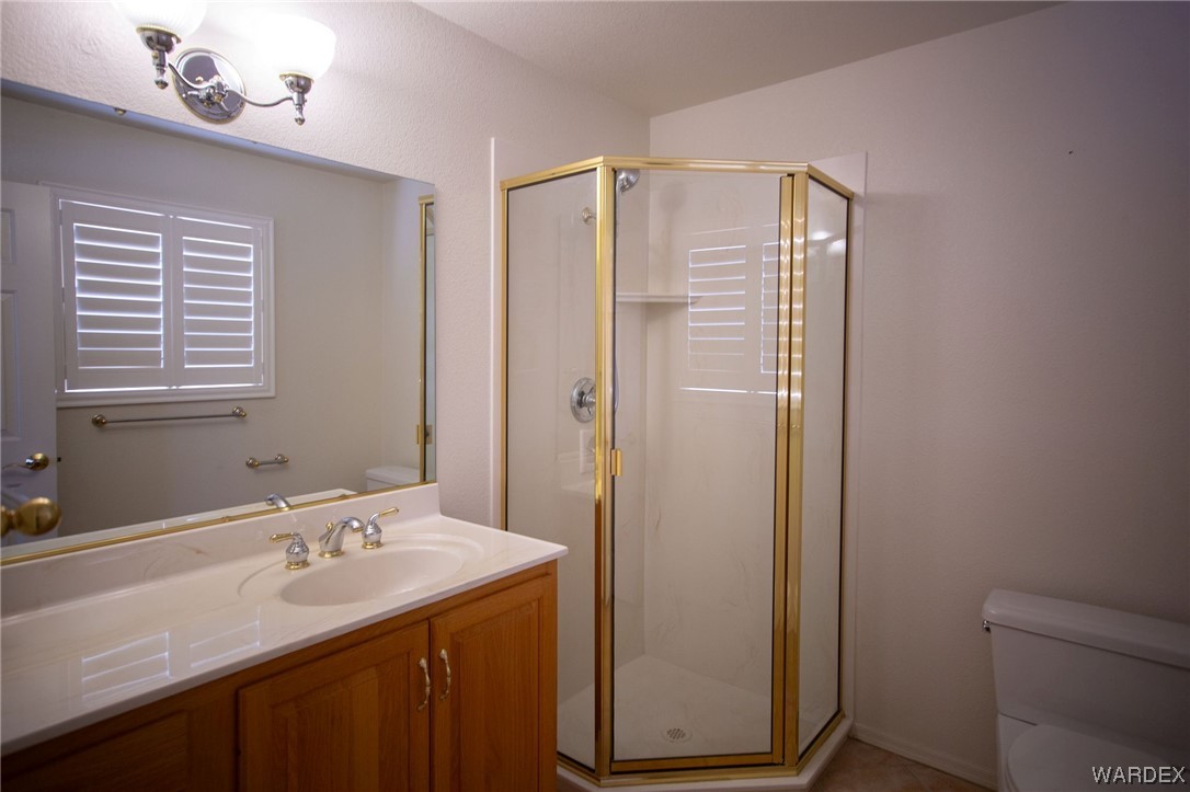 2660 Pegasus Ranch Road Bullhead City, AZ 86429 - Photo 31 of 57 a bathroom with a sink a mirror and a shower