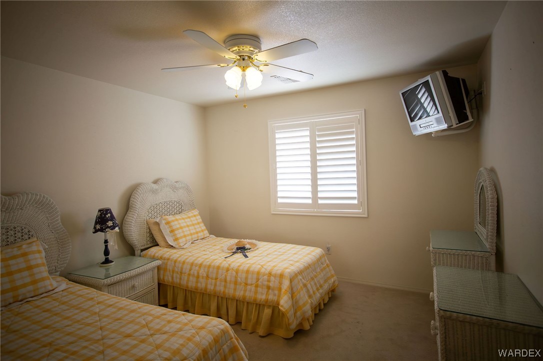 2660 Pegasus Ranch Road Bullhead City, AZ 86429 - Photo 32 of 57 a bedroom with two beds and a chandelier