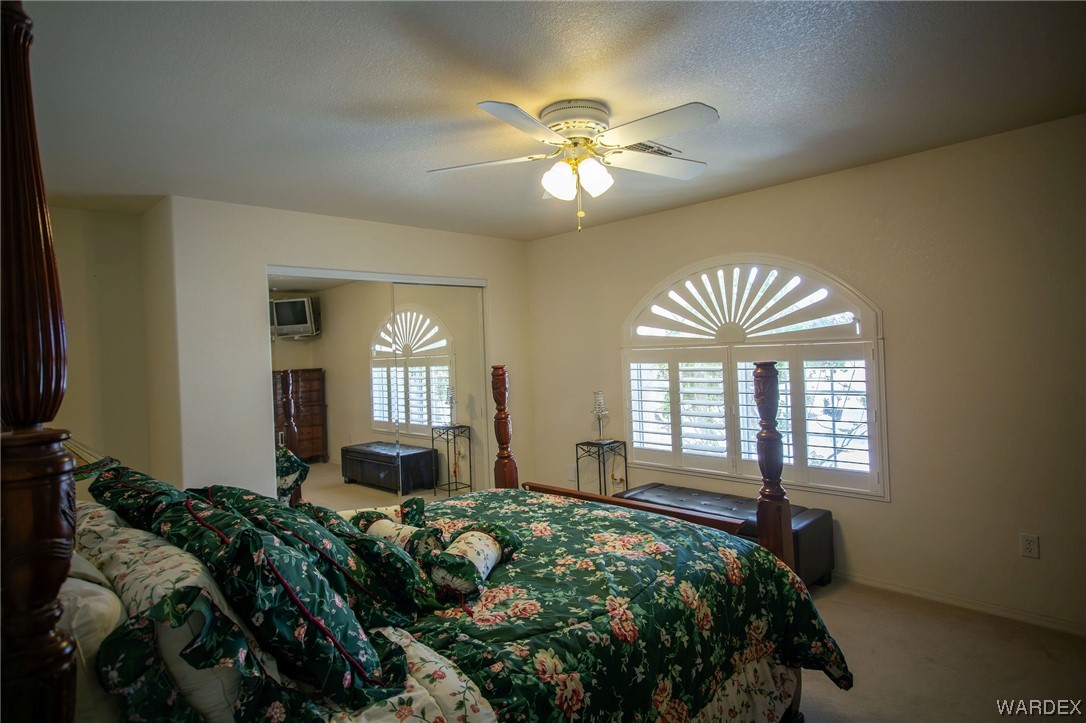 2660 Pegasus Ranch Road Bullhead City, AZ 86429 - Photo 35 of 57 a bed room with a bed and two windows