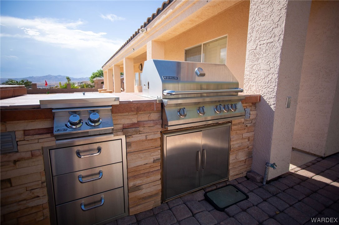 2660 Pegasus Ranch Road Bullhead City, AZ 86429 - Photo 48 of 57 a stove top oven sitting inside of a kitchen