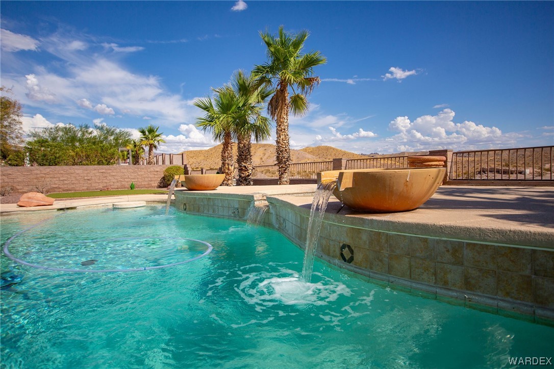 2660 Pegasus Ranch Road Bullhead City, AZ 86429 - Photo 51 of 57 a backyard of a house with table and chairs