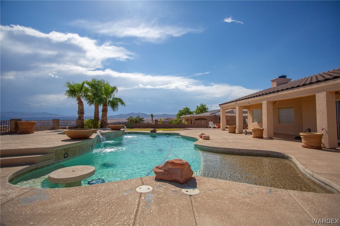 2660 Pegasus Ranch Road Bullhead City, AZ 86429 - Photo 52 of 57 a swimming pool with outdoor seating and yard