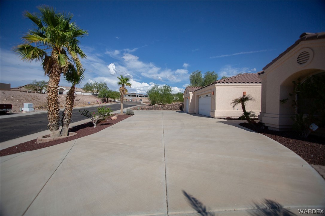 2660 Pegasus Ranch Road Bullhead City, AZ 86429 - Photo 54 of 57 a row of palm trees in front of a building